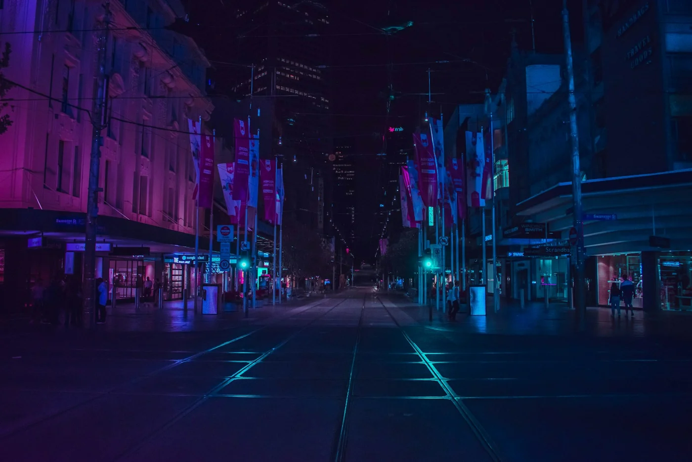 A city street illuminated after dark